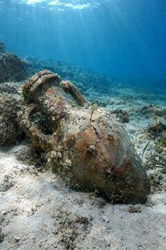 Ancient Amphora Partially Buried on Mediterranean Seabed in Underwater Archaeological Site