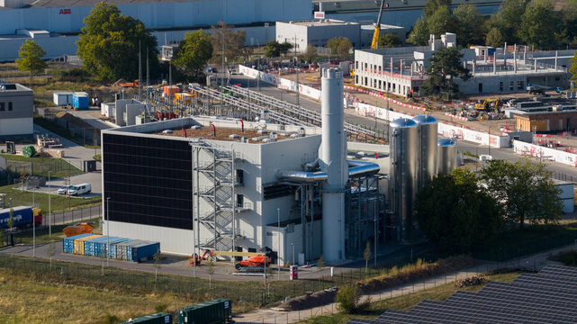 Aerial view of Data4 Hanau data center facility with industrial buildings, metal silos, and surrounding construction site in Hanau, Hessen, Germany.