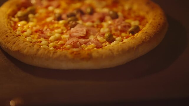 Baked Pizza Topped With Ham Corn And Green Olives