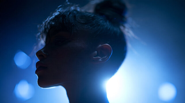Silhouette Profile of Young Woman in Blue Stage Light