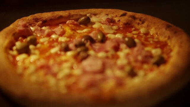Freshly Baked Pizza Topped With Ham Cheese And Green Olives. Italian Cuisine