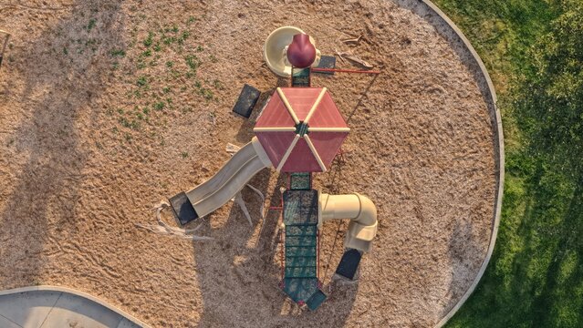 Aerial view of a playground structure with slides and a roof, set in a wood chip area in Eaton, Colorado, United States.