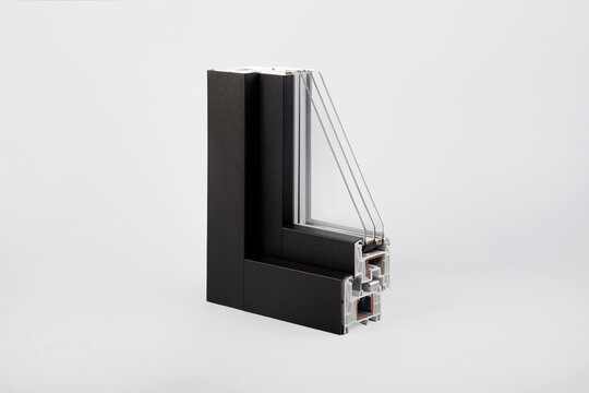 Cross section sample profile of black plastic window frame with triple pane glass unit on white
