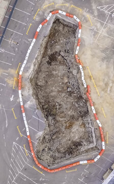 Aerial view of the Boring Company tunnel construction site featuring a large excavation pit surrounded by orange and white safety barriers in Nashville, TN, United States.