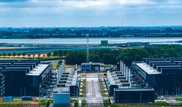 Aerial view of Agriport A7 industrial area featuring large data center facilities, modern infrastructure, and expansive greenhouses in Middenmeer, Noord-Holland, Netherlands.