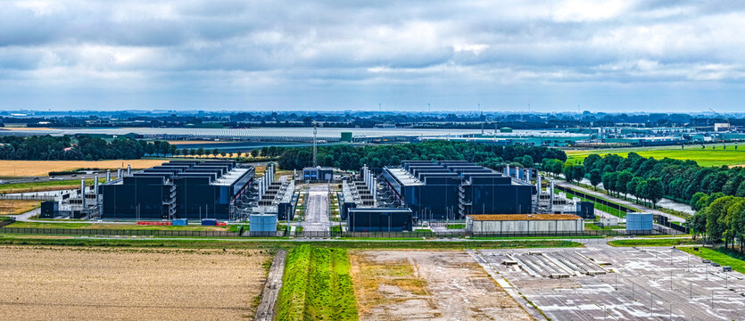 Aerial view of Agriport a7 data center facility surrounded by agricultural fields and greenhouses in Middenmeer, Noord-Holland, Netherlands.