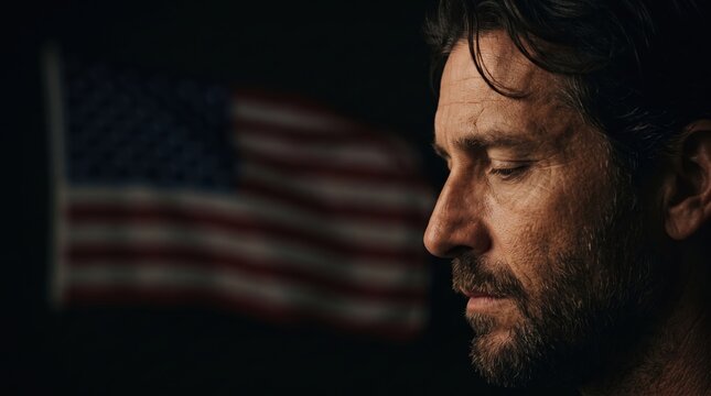 Portrait of a Pensive Man with an American Flag in the Background During Dusk