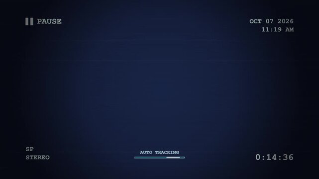 A vintage video cassette recorder interface displays a paused recording state with date stamps and audio settings visible upon the dark blue television screen during a playback session