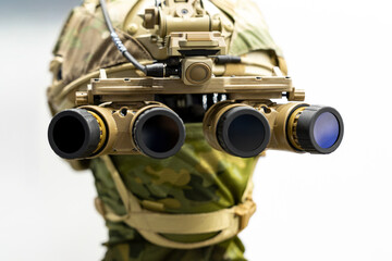 Fototapeta premium Military night vision goggles mounted on tactical helmet in close frontal perspective. Panoramic four lens optical device attached to special forces combat headgear.