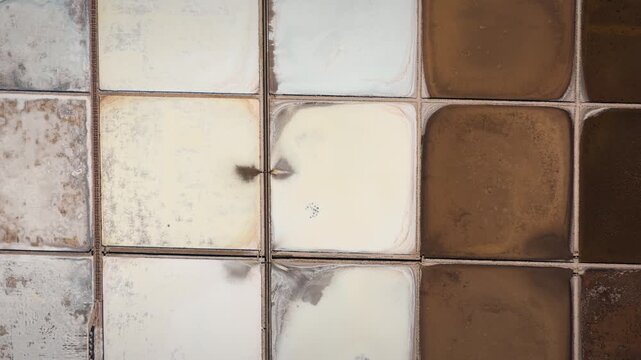 Drone shot of Ston salt pans reveals geometric pools in hues of white and brown, highlighting salt crystallization, mineral textures, and unique evaporation patterns.