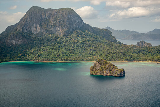Island with rocky formation and tropical greenery