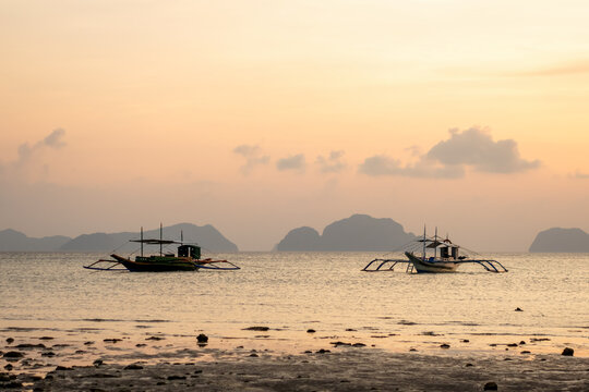Two boats float on calm sea