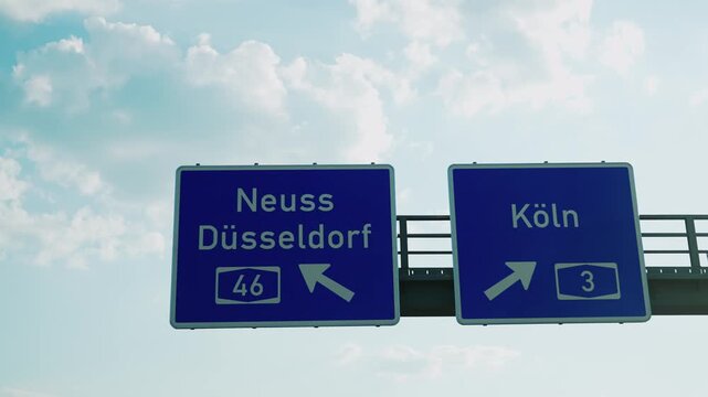 Drive pov under blue direction sign with the words Neus, Dusseldorf and Cologne