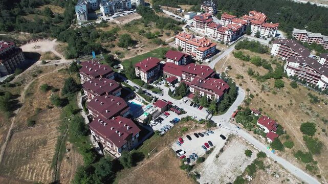 A view of a town Bansko with a lot of buildings and hotels, aerial shot