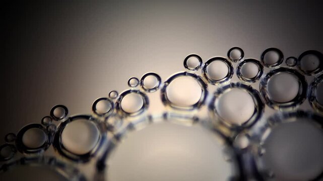 Macro 4K video of soap bubbles formed in a crown shape with rack focus effect