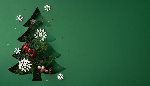 Creative vision of Merry Christmas and Happy New Year with cutout Christmas tree, pine and snowflakes on wide template