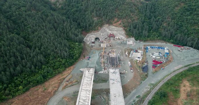 Tunnel road construction site with a large bridge in the middle, aerial shot