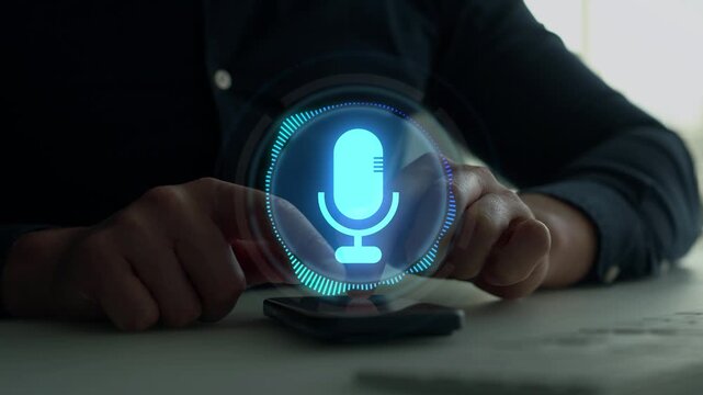 Close-up man using smartphone with virtual microphone.Voice recording and voice search concept.Sound recording or voice search with ai, speaker, music, voice message,assistance and marketing.