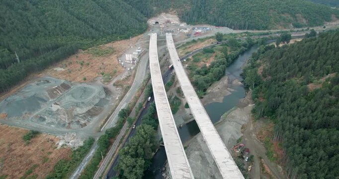 A construction site with a large tunnel being built at new highway, aerial shot