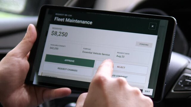 Fleet manager reviews a vehicle maintenance request on a tablet, highlighting digital approvals, service budgeting and cost control in modern transport operations.
