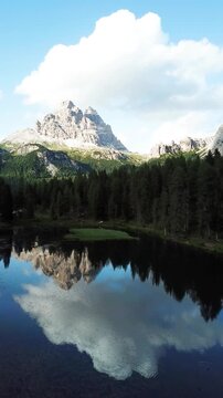Vertical alpine lake and mountain reflections in the Dolomites Italy