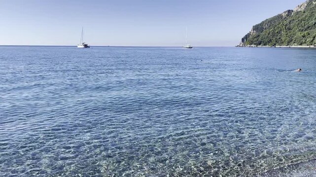 Crystal clear Liguria sea sailboats scenic coastline. Mediterranean luxury lifestyle serene travel escapism. Marine eco tourism sailing wellness vacation.