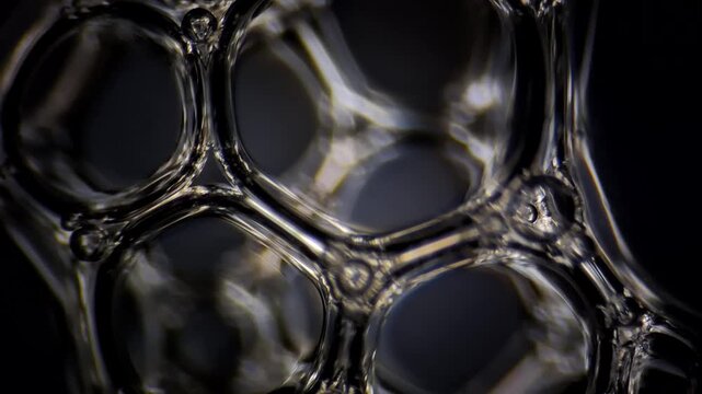 Macro 4K video of soap bubbles formed in a crown shape with rack focus effect