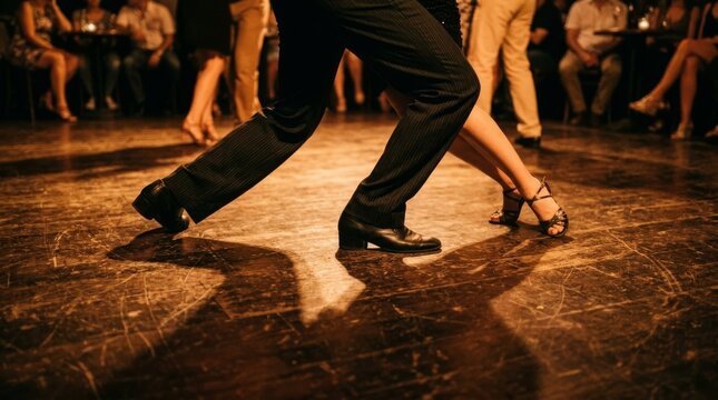 A man and woman dance tango on a dark wooden floor in the club.