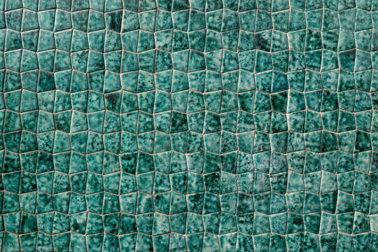 Unique mottled green trapezoid shaped tile pattern background texture