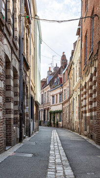 Quaint narrow alley full of beautiful historic buildings in Lille, France, Europe
