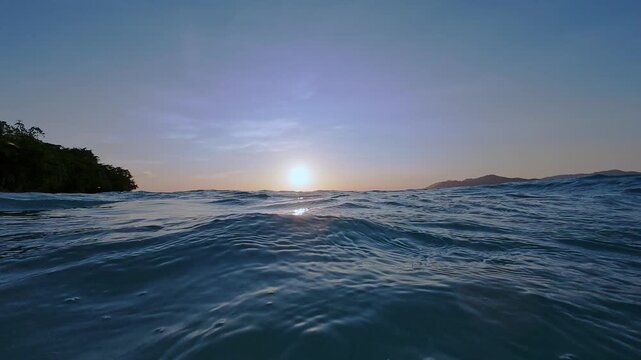 Low Angle View of Ocean Waves at Sunrise