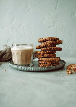 Stack of Muesli biscuits with a glass of almond milk