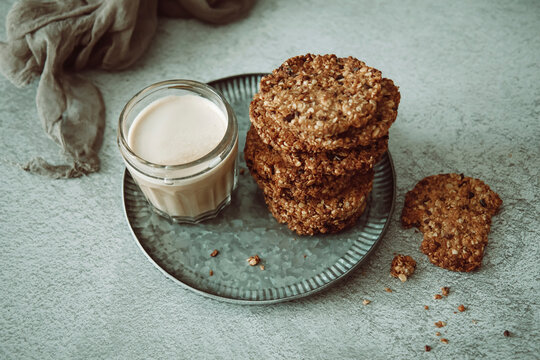 Stacked Muesli biscuits with almond drink on plate