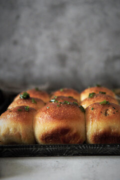 Yeast rolls with herbs on tray