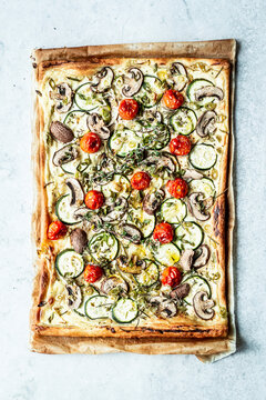 Puff pastry pizza topped with summer vegetables