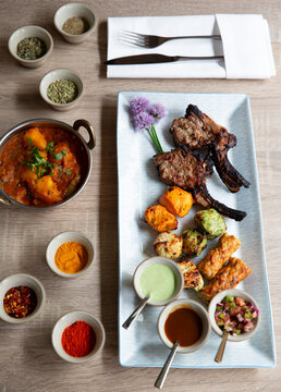 Indian grill platter with lamb chops, grilled vegetables