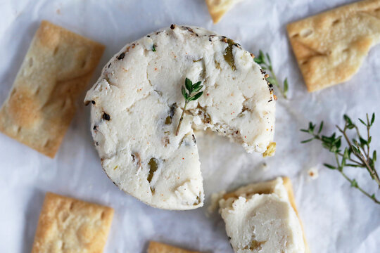 Vegan thyme cheese with crackers and fresh thyme herb