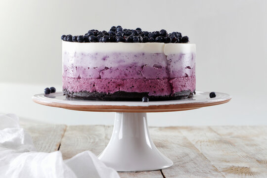 Blueberry Ombre Cake with layered cream and berry topping