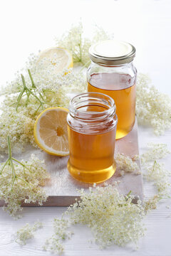 Flower syrup with lemon in glass jars
