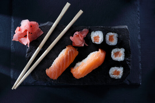 Nigiri sushi and hosomaki sushi rolls with fresh salmon fillet