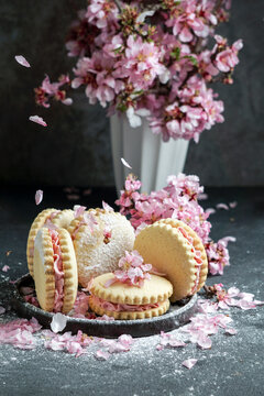 Alfajores sandwich cookies with cream filling and flower decoration