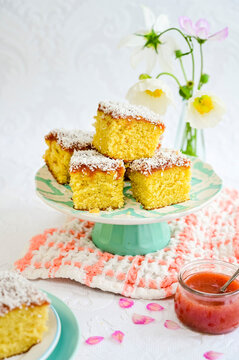 Marmalade coconut cake slices with jam and coconut flakes