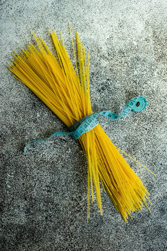 Spaghetti pasta wrapped with measuring tape for weight loss concept