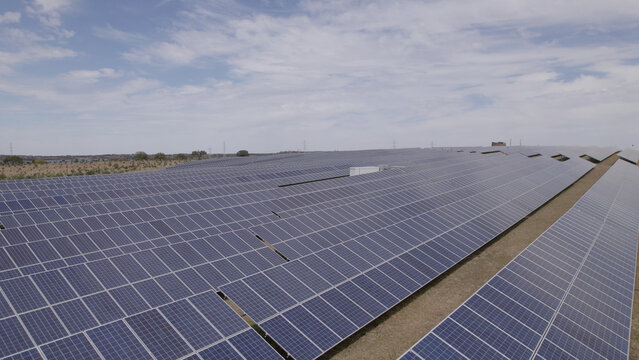 Aerial view of a large solar farm with rows of photovoltaic panels in the rural landscape of Ourique, Beja District, Portugal.