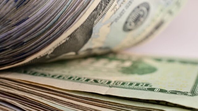 Stock of hundred dollars bills bokeh macro close up, texture, in and out of focus, abstract money finances, studio selective focus real time video	