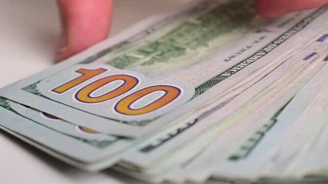 Stock of hundred dollars bills bokeh macro close up, texture, in and out of focus, abstract money finances, studio selective focus real time video	