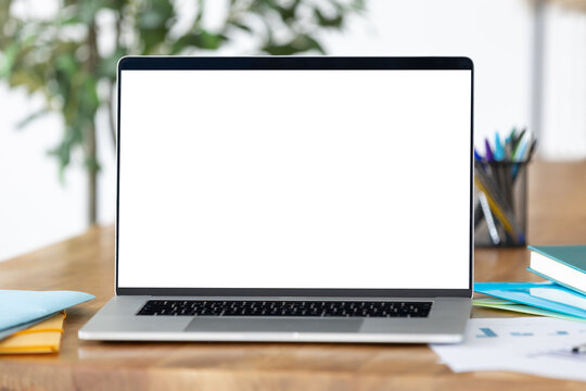 Last generation laptop mockup with blank screen at home office table