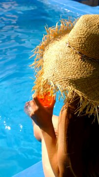 Friends drinking cocktails by the pool. Selective focus.