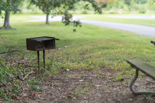 shallow focus dream like memory of summer BBQs in the park on those crappy iron charcoal grills that were always rusty and dirty with leftover ash and food scraps left on them