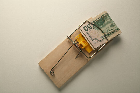 Mousetrap with money on white background, top view. Economic crisis
